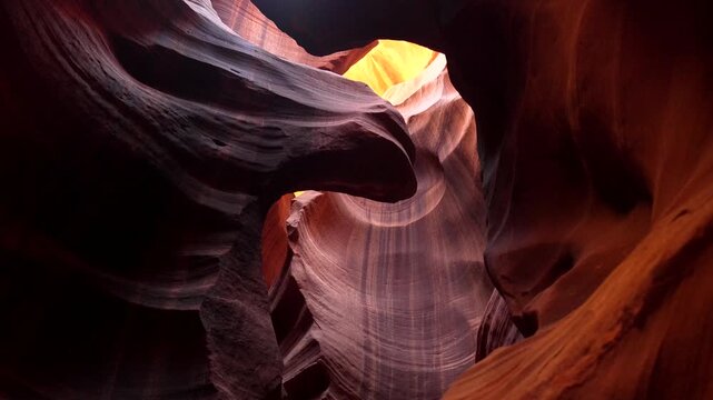 Famous red sandstone walls of antelope canyon showing beautiful textures and curves while sunlight from above creates stunning light and shadow plays in this iconic slot canyon near page, arizona