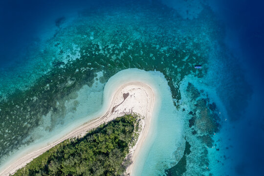Aerial view of Yasawa Island featuring a white sandy beach and lush tropical vegetation surrounded by vibrant coral reefs and turquoise waters Nadi, Western Division, Fiji.