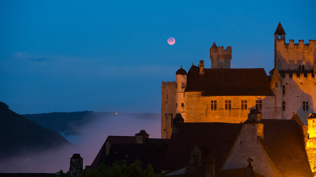 Chateau de Beynac at Night with Moon over Misty Valley