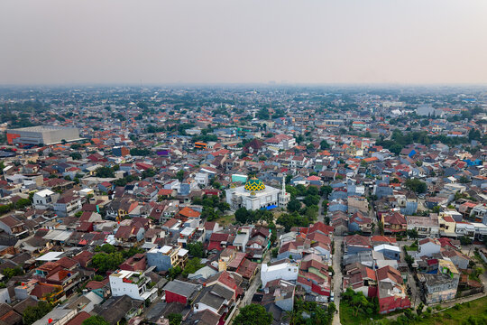 Sprawling cityscape of Jakarta showing heavy air pollution and dense neighborhood