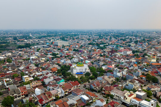 Dense residential neighborhood in a major city covered in heavy smog and haze