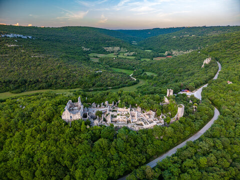 Aerial view of the medieval Dvigrad ruins nestled among lush green forests and rolling hills under a soft evening sky Kanfanar, Istria County, Croatia.