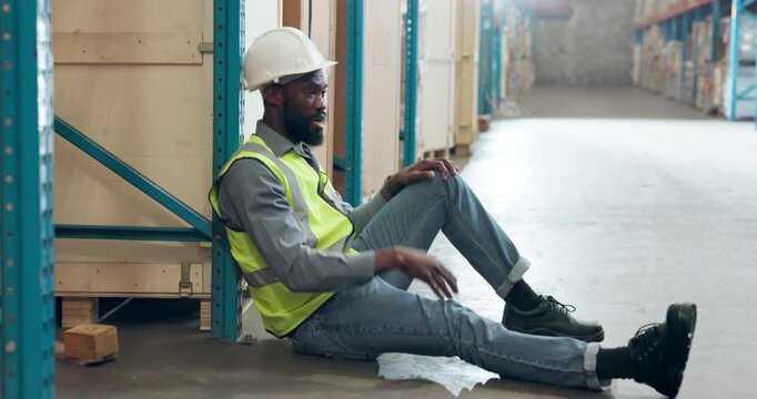 Break, distribution and stress with black man in factory for delivery, logistics or supply chain. Fail, tired and warehouse with inventory or stock on shelves for backlog, courier service and delay