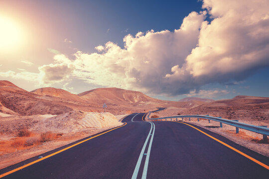 Driving a car on a mountain road. Desert landscape. The road from Arad to the Dead Sea. View from the car of the mountain landscape on a sunny day. Israel
