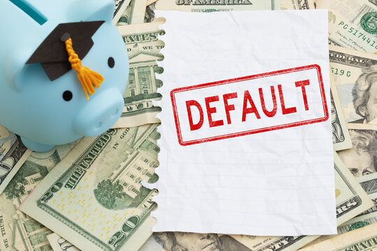 Default text with piggy bank with grad cap with torn blank paper on twenty dollar bills for student loan payments