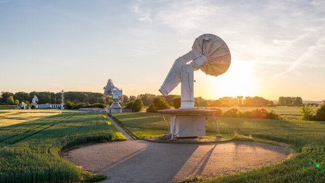 Aerial view of the Satelliten-Messstelle Leeheim satellite monitoring station with large parabolic antennas in green fields during sunset in Riedstadt, Hessen, Germany.