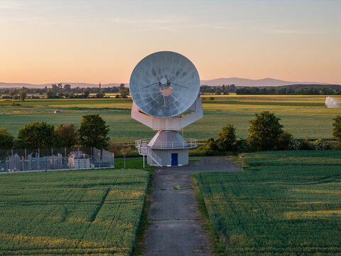 Aerial view of the Satelliten-Messstelle Leeheim satellite dish antenna surrounded by green fields at sunset in Riedstadt, Hessen, Germany.