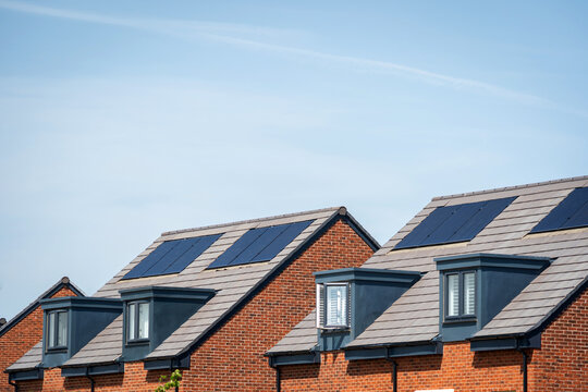 Photovoltaic solar panels on the roof of new built house in england uk. The concept of a sustainable environment, construction.