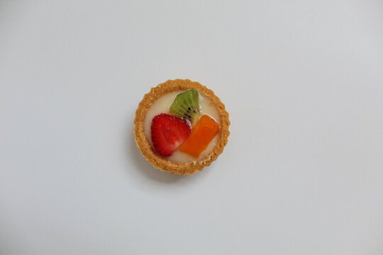 Pie Buah Mini, popular dessert in Indonesia. Crisp tart with vla and fruit slices. Isolated on white background. Top view or flat lay