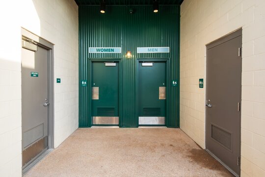 Exterior entrance to public male and female restrooms with green doors