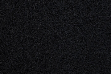 Fototapeta premium The background image shows a freshly laid asphalt surface, just a few hours old, with a clear, almost completely black texture.