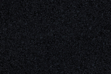 Fototapeta premium The background image shows a freshly laid asphalt surface, just a few hours old, with a clear, almost completely black texture.