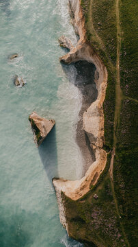 Top down aerial view of coastal chalk cliffs and turquoise ocean