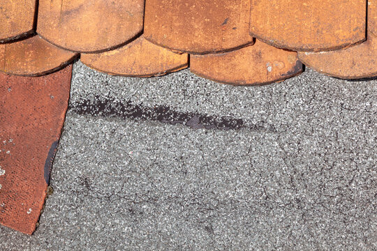 detail of damaged roof of a family house with old beaver tail