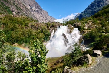 powerfull Kleivafossen waterfall with a rainbow and glacier background © eve