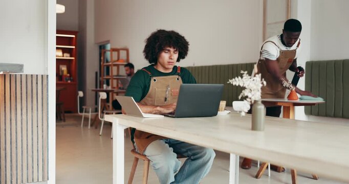 Stretching, laptop and man in cafe with yawn, completed task and overworked in posture adjust. Tired, burnout and employee in coffee shop with tech, exhausted and back pain in work deadline.