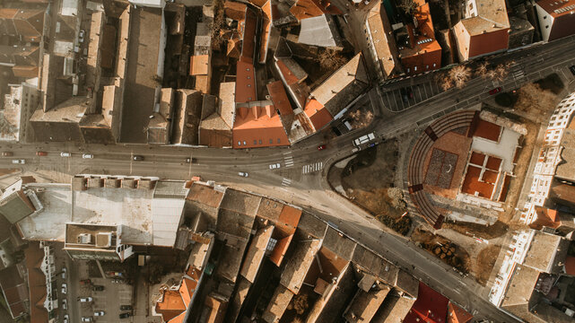 Aerial view of the historic city center featuring red-tiled rooftops and ancient Roman ruins at an urban intersection in Sremska Mitrovica, Vojvodina, Serbia.