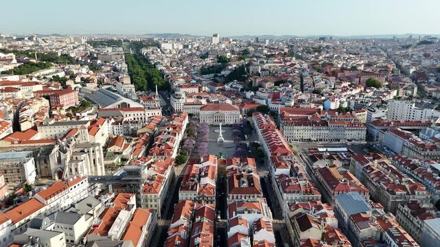 Drone Flyover Above Rossio Square and Jacaranda Trees in Lisbon