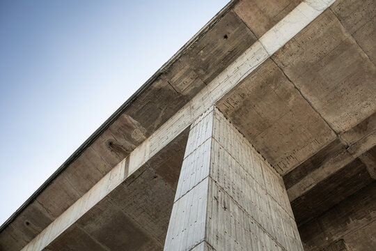 Highway bridge concrete pillar and underside from low angle