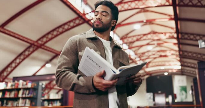 Books, university and man in library for education, learning or research with knowledge. Studying, reading and male student with academic information for college exam, project or assignment on campus