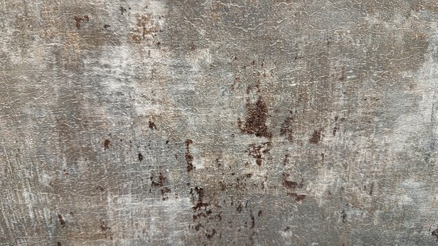 Vintage gray grunge wall texture with brown rust stains, antique concrete background with cracks