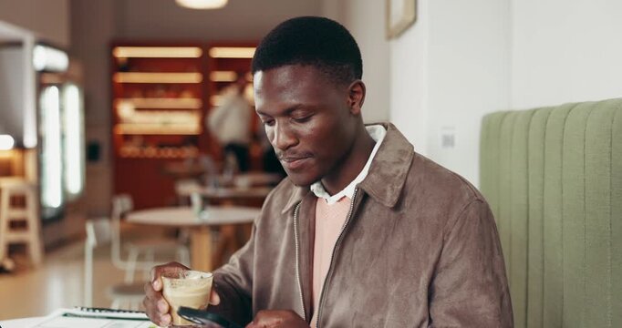 African man, drink and coffee in restaurant with phone, online work and reading email on mobile. Happy, person and entrepreneur in cafe with technology, laptop and beverage for remote business.