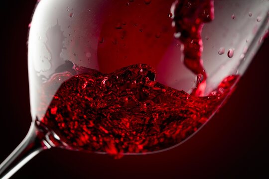 Red wine is poured into a glass.