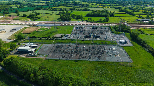 Aerial view of Berkswell Substation National Grid featuring electrical infrastructure and pylons surrounded by green fields and construction work in Coventry, England, United Kingdom.