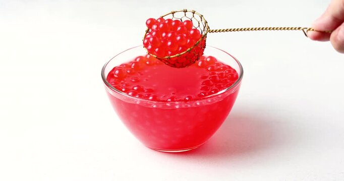 Juice balls in glass. Trendy drink. Cold iced fruit bubble tea 	