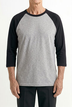 Studio portrait of man wearing blank grey and black raglan baseball t-shirt mockup, commercial apparel template on white background