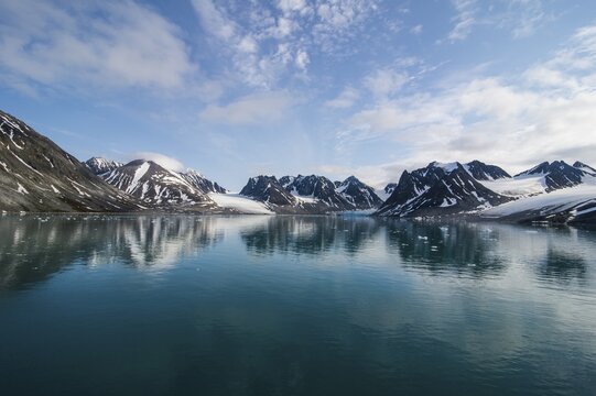 Mountains reflecting in the water in the Magdalenefjorden, Svalbard, Arctic, Norway
