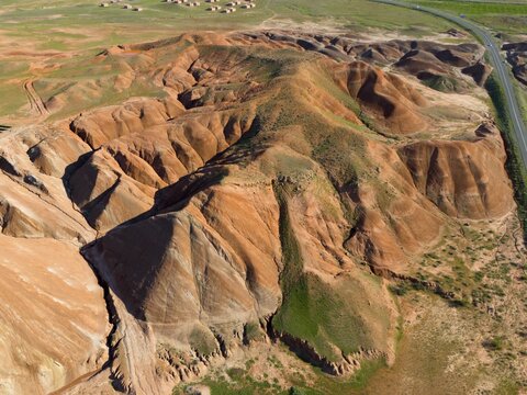 Aerial view of a hilly landscape dominated by ochre-coloured rock formations and small areas of vegetation, aerial view, mountains on D70 and D80, Tuzluca, Igdir Province, Iğdır, Eastern Anatolia, Anatolia, Turkey