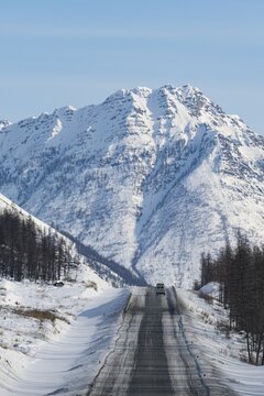 Minivan driving on the Road of Bones, Suntar-Khayata Range, Sakha Republic, Yakutia, Russia