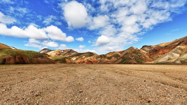 Dry riverbed, behind it coloured rhyolite mountains, volcanic landscape, Landmannalaugar, highlands, Iceland