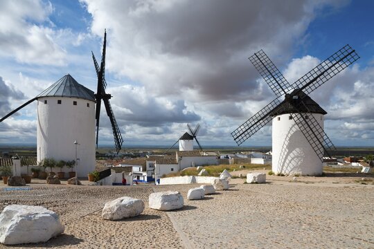 Three windmills in a village under a cloudy sky, Campo de Criptana, Ciudad Real province, Castilla-La Mancha, Don Quixote Route, Spain