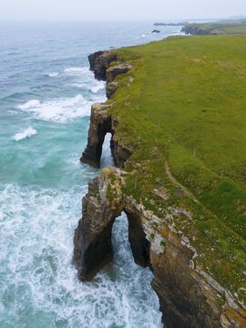 Steep coastline with characteristic rock arches and thundering waves crashing against the rocks, aerial view, Praia das Catedrais, Playa de las Catedrales, Cathedral beach, As Catedrais beach, Cantabrian Sea, Ribadeo, Galicia, Galicia, Spain