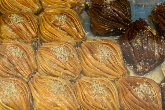 Midye baklava traditional Turkish dessert with pistachios and syrup in a tray. Oriental sweets background for Middle Eastern restaurant advertising banner and ramadan holiday food concept