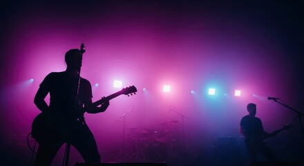 Obraz premium Energetic Live Music Performance with Guitarist Silhouette and Colorful Stage Lights in Hazy Atmosphere