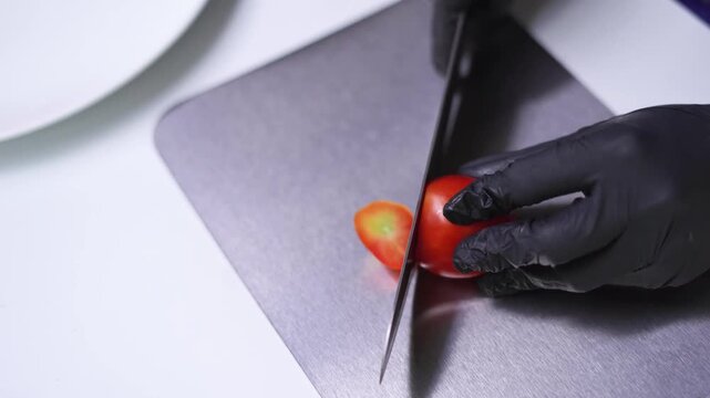 Close-up of cutting tomato on kitchen chopping board. video footage 4k