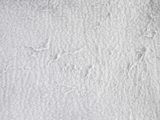Light gray fleece fabric texture with pilling and lint close up © sunkit