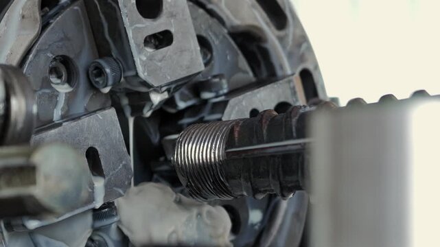 Threaded rebar machining with coolant on industrial machine in slow motion