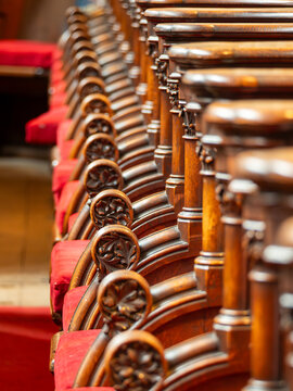 Wooden pews in a row in Lichfield Cathedral, UK
