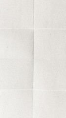 Fototapeta premium A textured, folded white paper background with subtle creases.