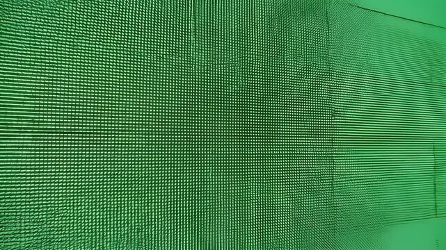 Close-up textured green wall with horizontal lines and grid patterns