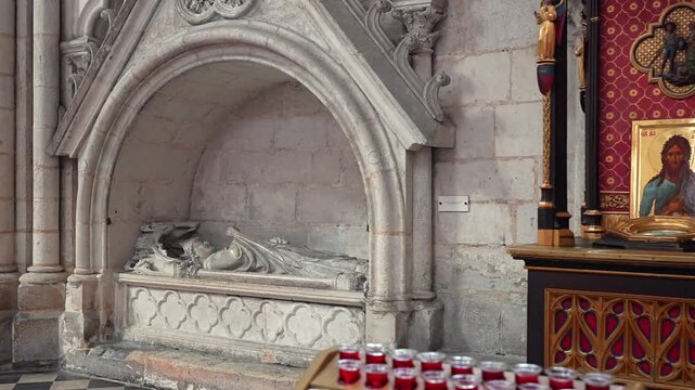 Amiens Cathedral chapel with stone tomb sculpture icons and red votive candles