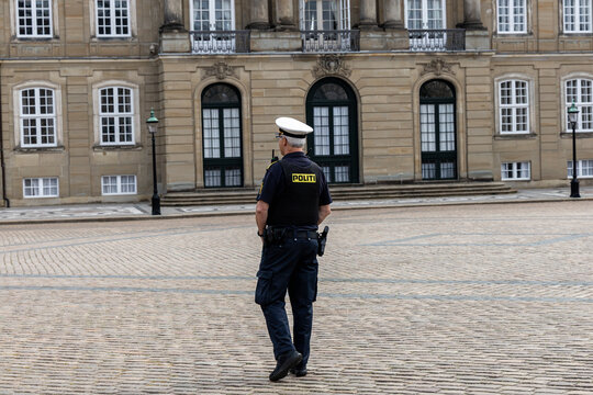 Danish police officer guarding Amalienborg Palace in Copenhagen, Denmark