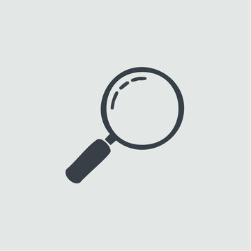 A magnifying glass is being used for inspection and analysis on a plain surface.