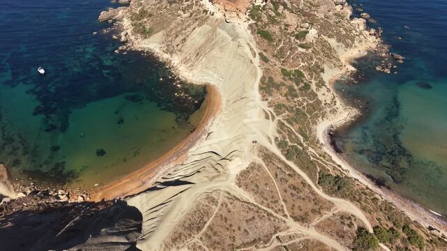 Cinematic Drone Tilt Up Revealing Qarraba Peninsula at Ghajn Tuffieha Bay, Malta