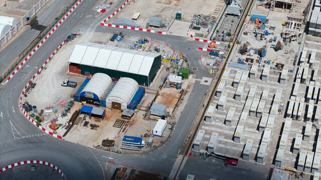 Aerial view of HS2 Concrete Segment Manufacturing and Production Site with large industrial tents and rows of precast concrete segments in Birmingham, England, United Kingdom.