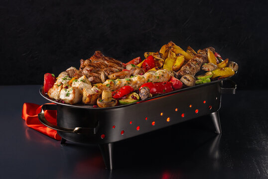 platter of different kebabs, kebab of pork, lula kebab, rack of lamb,chicken kebab,kebab of veal, grilled vegetables on plate